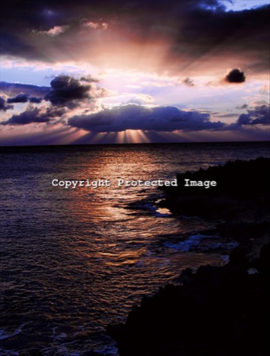The sun sets across the lava rock at Shark's Cove along the North Shore of Oahu.