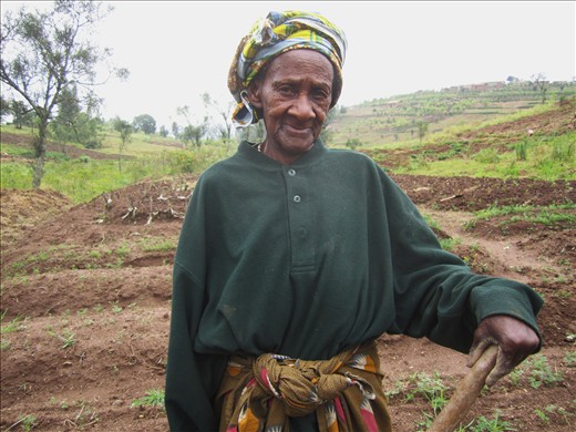 She is older than my grandmother, but can work her fields faster than anyone I have seen. I was told she lost much of her family to the Genocide, but was not looking for a handout. I wanted to capture her struggle, her toughness, and her diva-status all in one photograph, with her work behind her. I know I did not do her justice. 