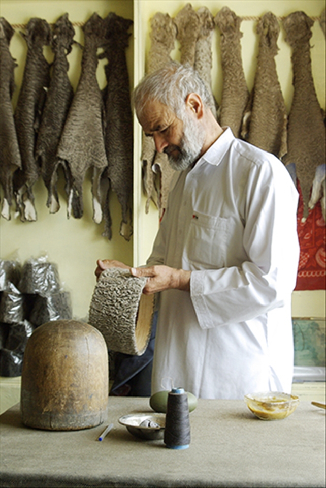 Local hatter crafts the traditional Qaraqul hat, made from the fur of an endemic breed of sheep, in Kabul. 