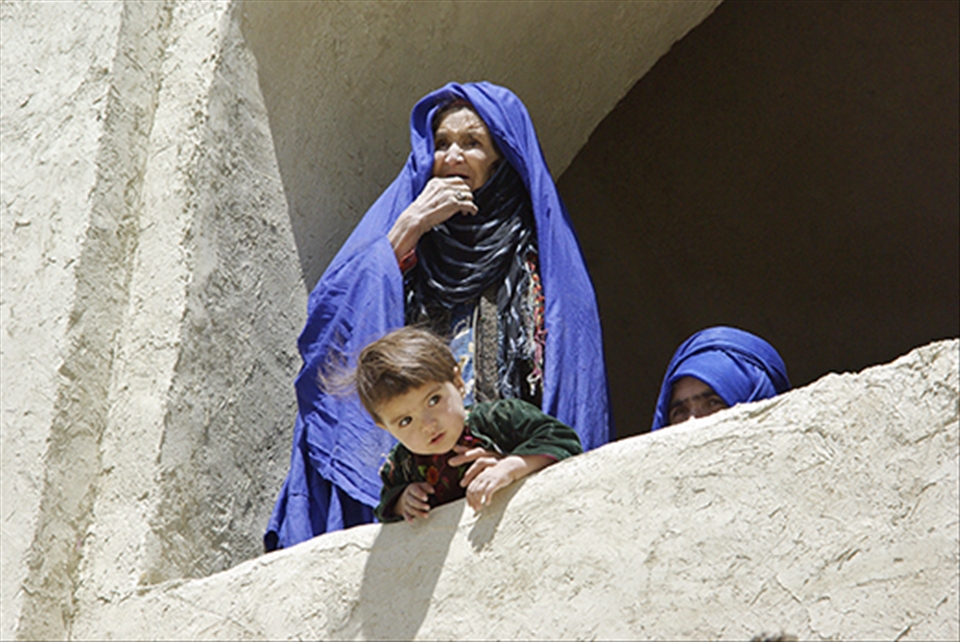 Rare scene of women uncovering their faces in public to feel the sun on their skin at a resting area by one of the six deep blue water lakes in Band-e Amir. 
