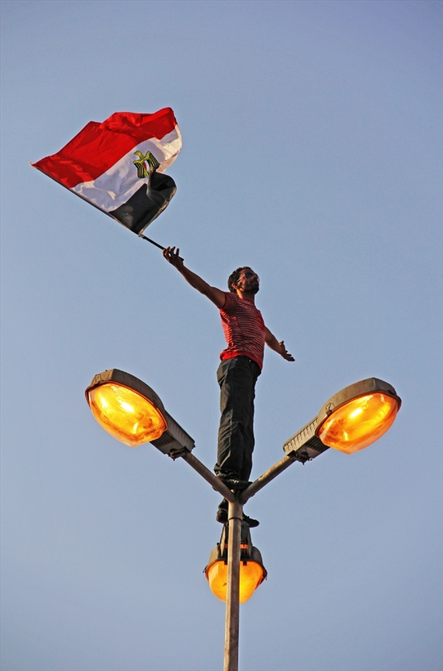 Freedom and fair democracy won’t come without expressing your point of view. A protestor standing on a light pole in Tahrir Square wanted to express the identity and the spirit of the revolution. Freedom needs Courage.