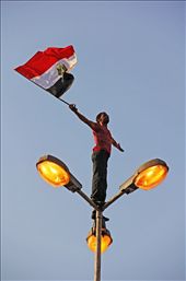 Freedom and fair democracy won’t come without expressing your point of view. A protestor standing on a light pole in Tahrir Square wanted to express the identity and the spirit of the revolution. Freedom needs Courage.: by mohamed-abdelkarim, Views[465]