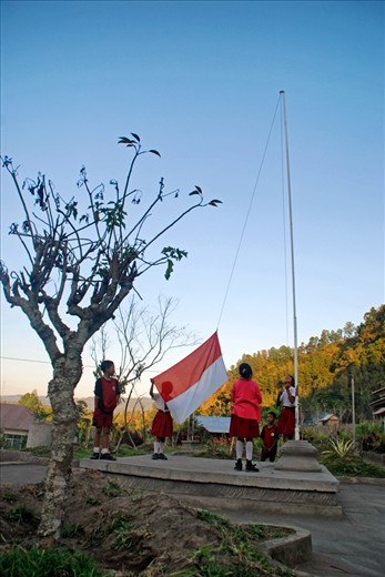 Children flying the Indonesia flag every morning. Elementary school located in the village Belandingan Belandingan, Kintamani, Batur District, Bali, Indonesia. Children - children come to school from 06.30am, upon arriving at school they share picket duty. Some school children were always clean the soiled with dust sand, some waving flags and others watering the plants. Children - children are always excited when flying the flag of Indonesia, for those flying the flag of an expression of their love for the country.
