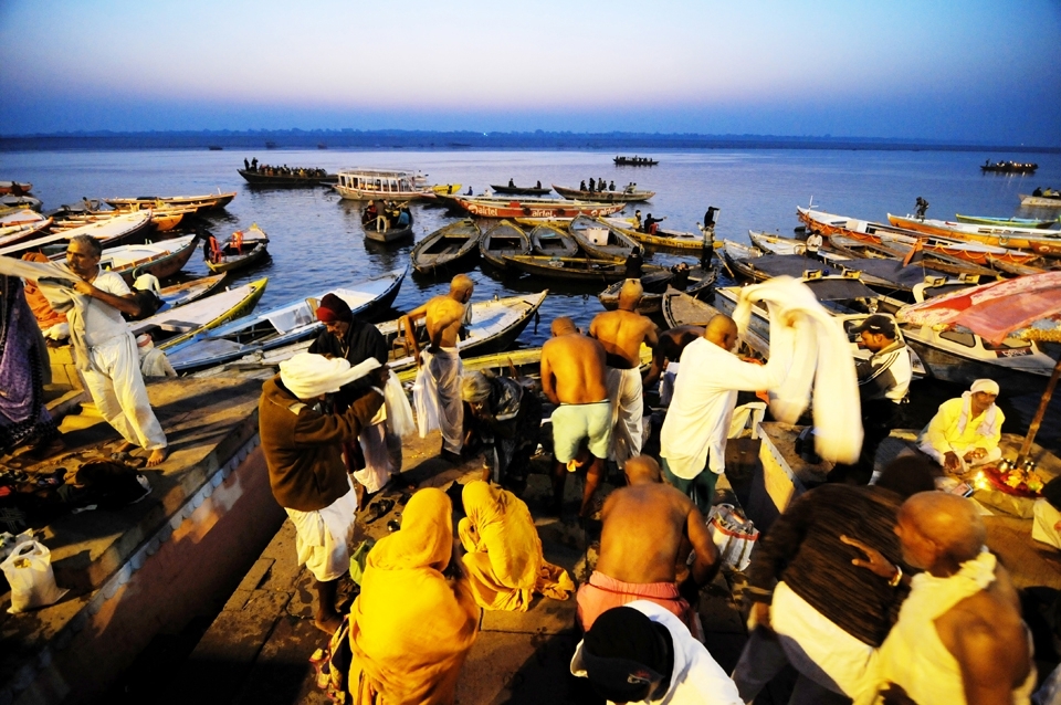 People bathing and performing religious rituals during dawn at the Ghat (shore) of river Ganges in Varanasi, India. Varanasi is the world's oldest living city on this earth, known for its cultures, heritage & traditions and also known as spiritual capital of India.