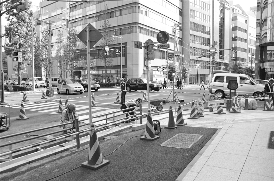 Guards at all corners of construction site telling pedestrians to be careful.
