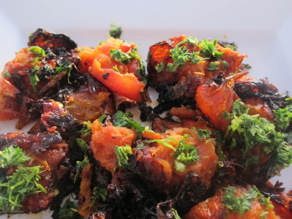 The tomatoes should be served toasted and shriveled up.  Remember that tomatoes are a fruit. The caramelization gives them a delicious sweet taste.
