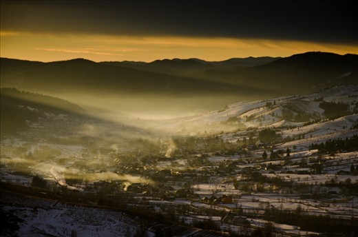 Sunrise over Humorului Valley. A place where time stands still and people preferto keep their old ways: working their lands, growing their animals, going to church and making fires in their shingle roofed homes...