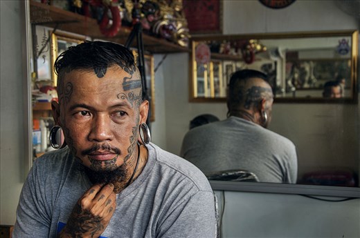 Local tattoo artist sits in his shop waiting for his next cilent. 