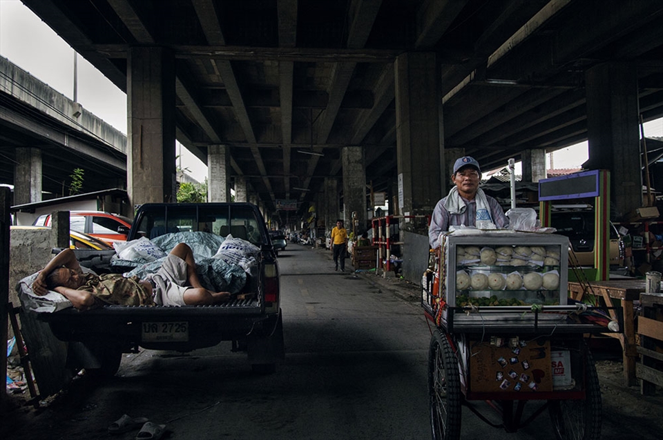 The main motorway divides the major banking district of Bangkok from the slums.