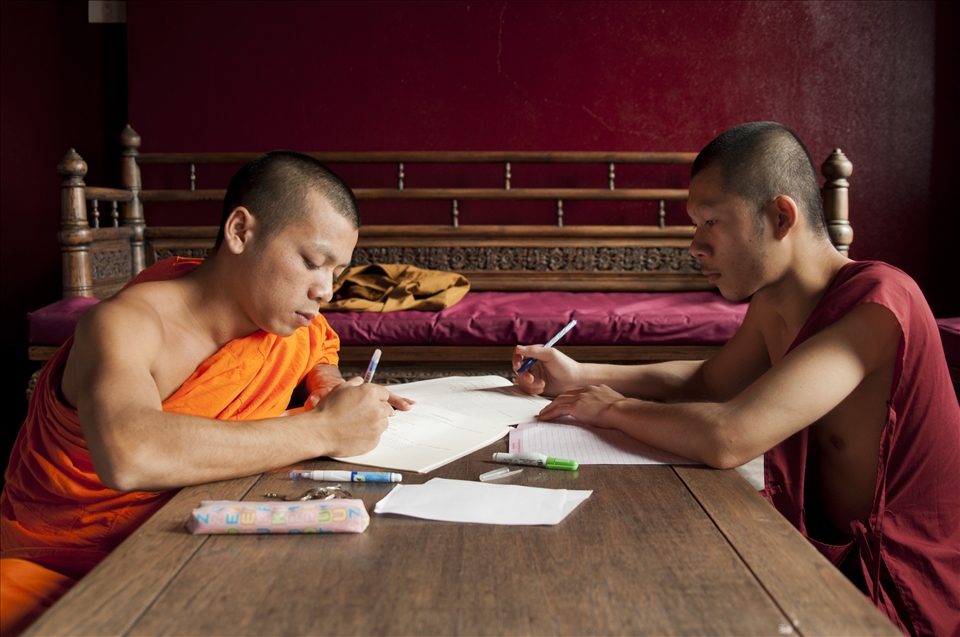 A long way from home two young Laotian monks are engrossed in their studies in one of the numerous monasteries in Chiang Mai in Thailand. They are two of the lucky ones who were allowed to go to Northern Thailand to get a better education. Most of the monks come from poor families who cannot support their child on their own and therefore send it to a monastery. 