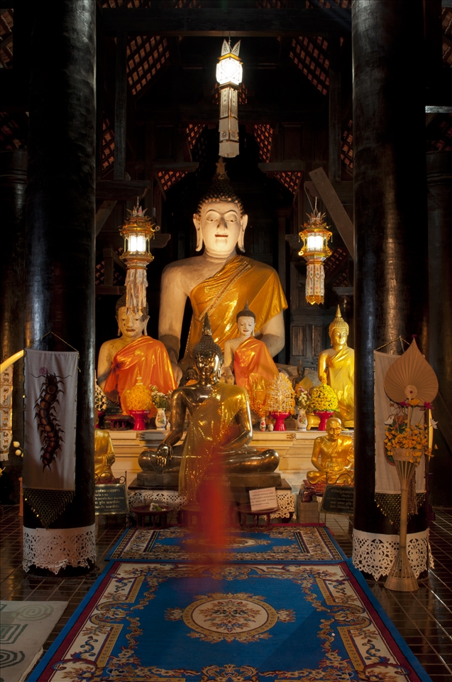 A long shutter speed only leaves a hint of a monk who worshiped late at night before going to sleep in his monastery. Many Laotian novice monks do not stay forever in Northern Thailand, when they have finished their studies.