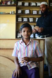 A young boy drinks chai masala while his father counts his days earnings.: by moosey84, Views[110]