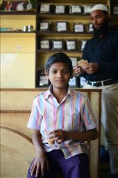 A young boy drinks chai masala while his father counts his days earnings.: by moosey84, Views[123]