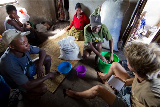 Fisheries researcher tallying market haul of local fishermen in their hut