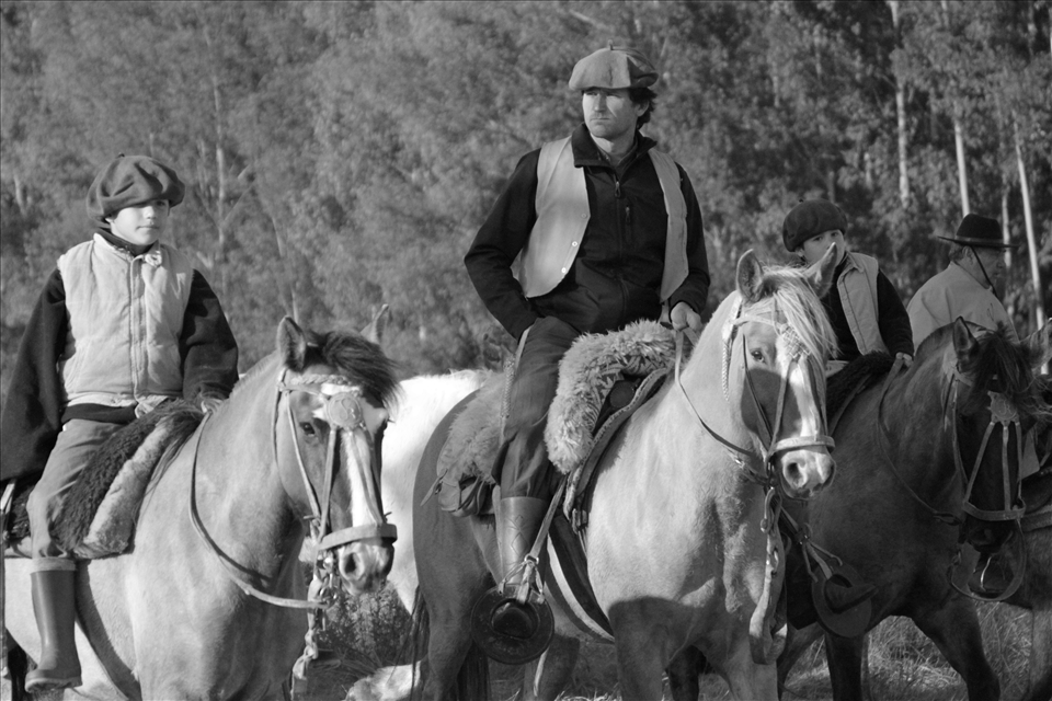 People of different ages celebrate the day of their local hero on a horse exodus. It takes two days with some stops.