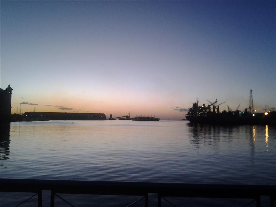 An evening in the port city of Mauritius, a ship waits at the dock 