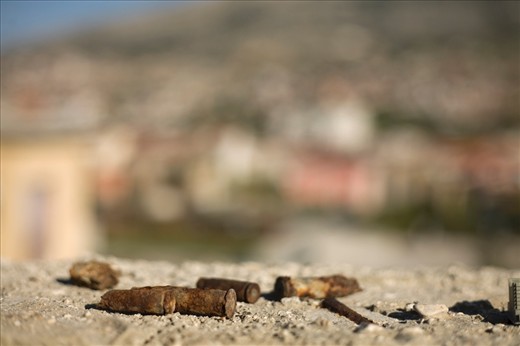 Bullet casings remain atop an abandoned building 18 years after the conclusion of the war. 