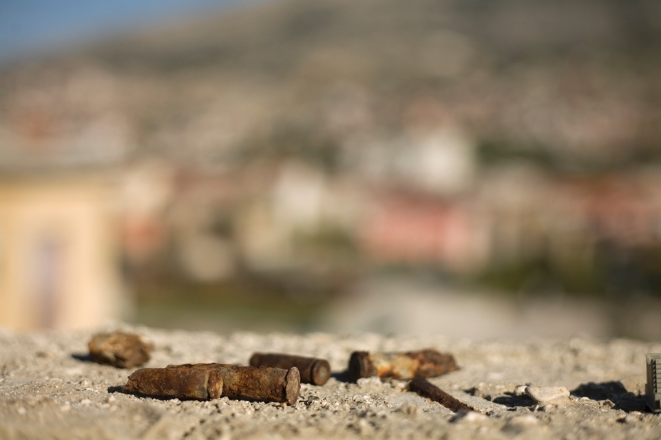 Bullet casings remain atop an abandoned building 18 years after the conclusion of the war. 