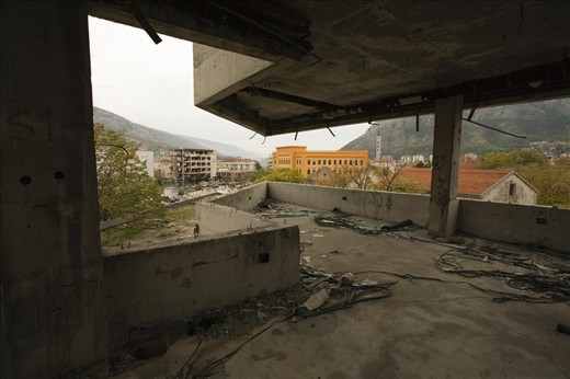 View from a former bank and the tallest building in the city of the Gymnasium Mostar; a public primary school and host to the United World College of Mostar. Gymnasium Mostar is one of few schools to allow students of all ethnic and religious backgrounds to study under one roof. 