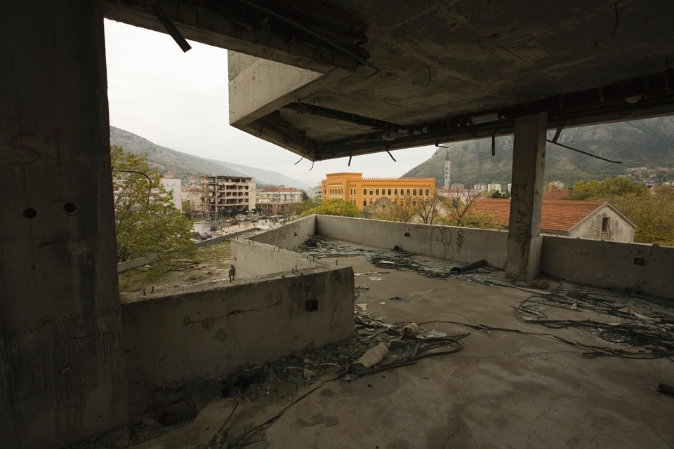 View from a former bank and the tallest building in the city of the Gymnasium Mostar; a public primary school and host to the United World College of Mostar. Gymnasium Mostar is one of few schools to allow students of all ethnic and religious backgrounds to study under one roof. 