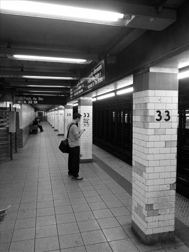 Over 4 million people use the New York City subway each day, so it wasn't uncommon to see people commute by themselves. In this particular photo I found a singular person waiting for the train next to a double three to be odd. This was the only time someone waiting for the train by themself seemed strange, as if he should have been accompanied by someone to complement the number.