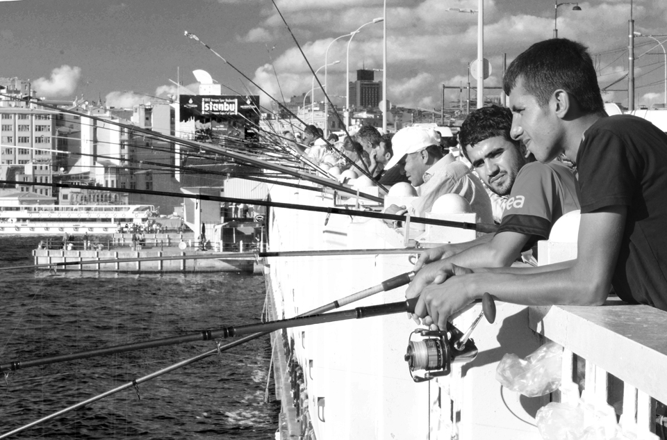 Fisherman stand shoulder-to-shoulder on Galata Bridge around the clock.