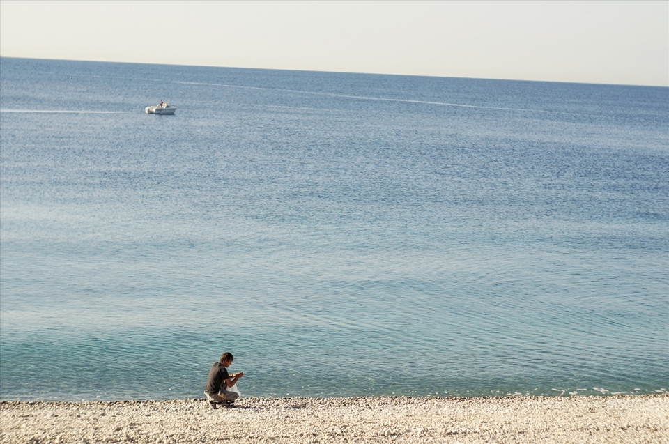 I met this man walking along the beach in a ragged pair of pants, carefully picking the pebbles and putting them into his plastic bag. He looked like the homeless people I saw sleeping near the train station, but his face was really calm and quiet. He said “Bonjour” and something else to me in French, but unfortunately, my French was just as bad as his English. He gave me a round pebble, and continued walking. 
“All the lonely people
Where do they all come from?”
I just can’t help myself but whispering this song.
