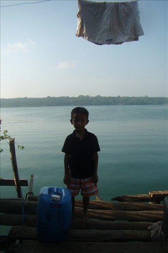 A Badjao kid poses against the sea view from the houses-on-stilts village.