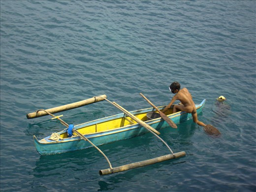 A young diver in the usual diving gear: birth suit and homemade fins.