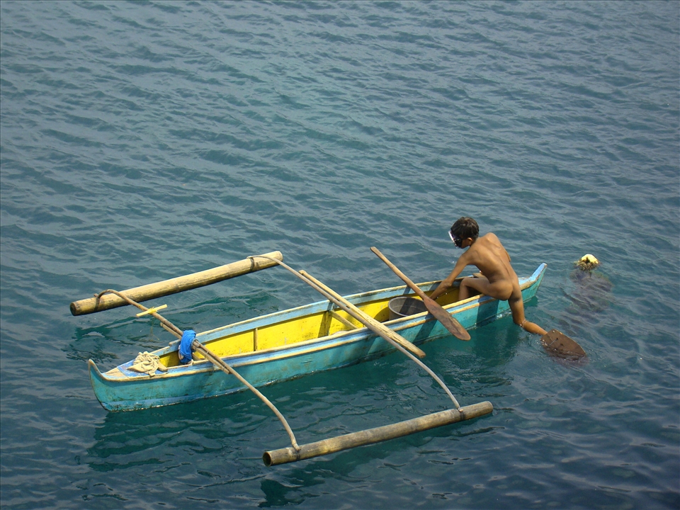 A young diver in the usual diving gear: birth suit and homemade fins.