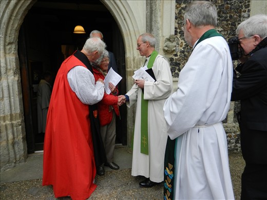 Archbishop of Canterbury (the one in the middle, shaking someone's hand