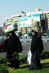 Two strong women in their abayas carrying big crates with no difficulty, in the middle of a busy street in Cairo.: by mutanterrante, Views[675]