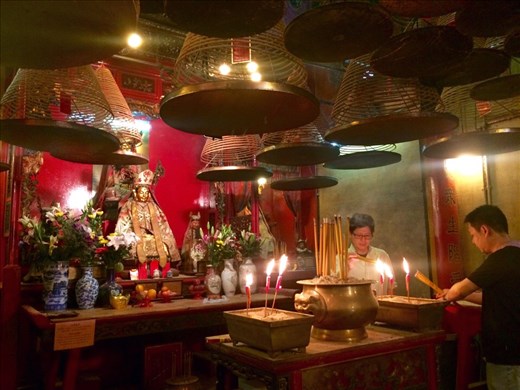 The lanterns and incense at the temple.  The triangular spirals are burning incense with a tin to catch the ashes hanging below them.