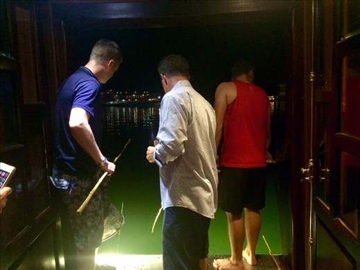 The guys catching our breakfast!  Squid fishing!