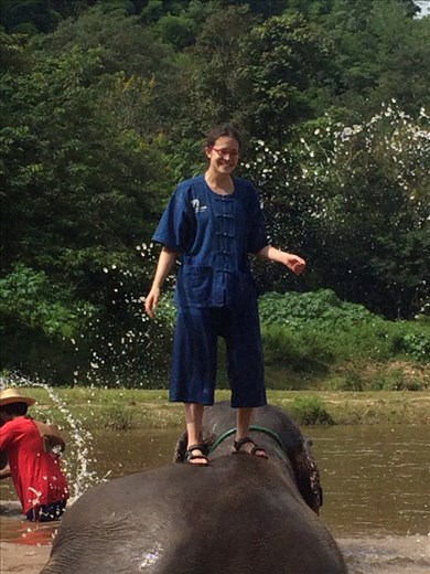 Riding and playing with the elephants.