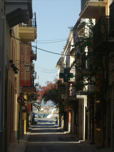 small roads full with blooming flowers its a characteristic of greek islands