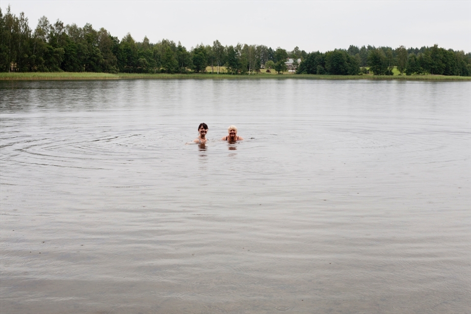 My sister and my mom are having a swim under the rain.