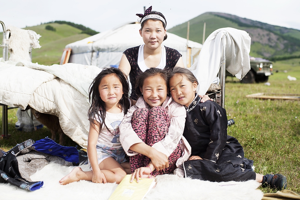 Three girls from two different families that host travellers