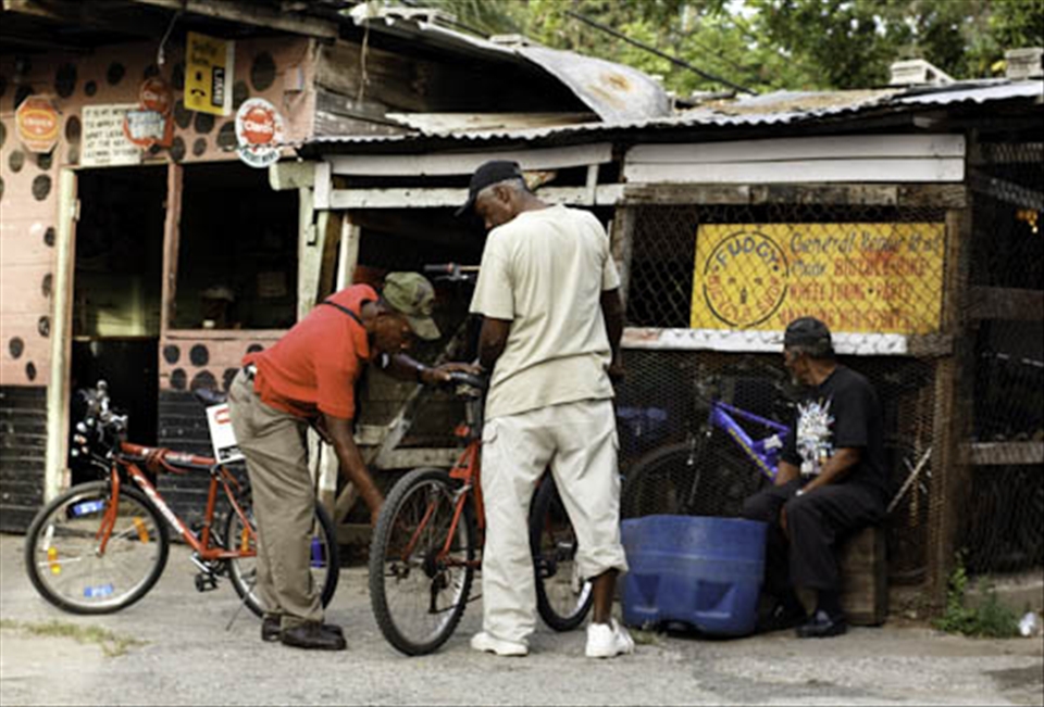 Self employment is a common practice in the Swallow Field Community. Here is a bar attached to a bicycle repair shop owned and operated by a man from the community known as Fudgy. Unfortunately Fudgy is not at work today he died a few hrs earlier in the hospital after his long standing battle with lung cancer was cut short. The shop is now closed.
