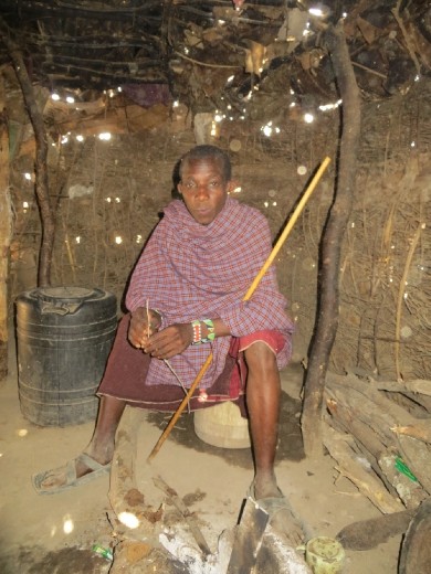 Inside one of their huts a warrior tells us about the Masai. The women build the huts and do most of the work around the village. The men tend to the herds of cattle and goats. Masai ONLY eat meat, milk and blood!