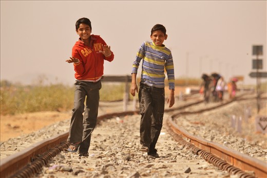 In the middle of the dessert train track this kids appeared smiling and dancing.