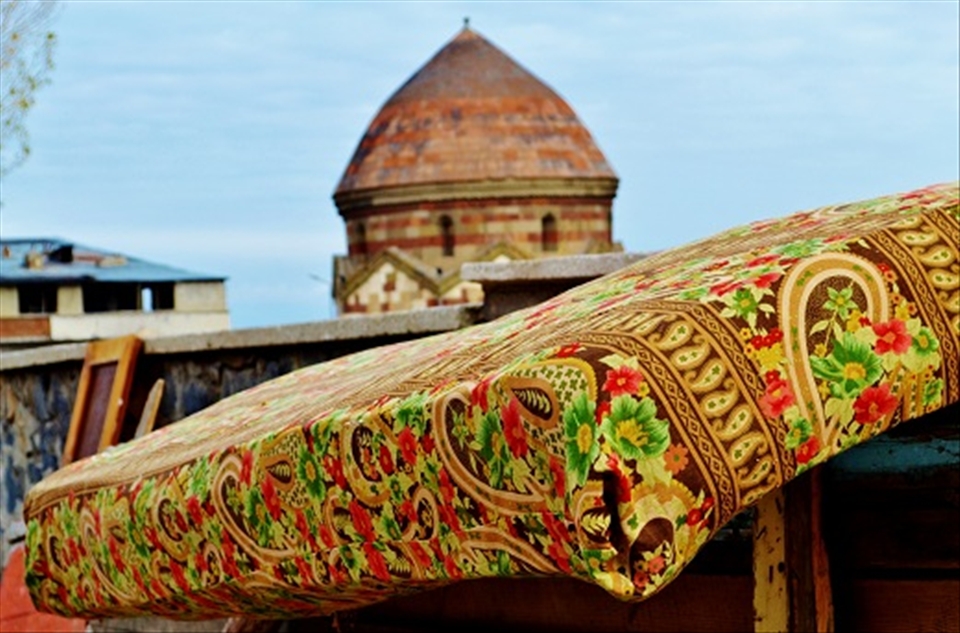 Title: Colors of Anatolia
This is an example of the beauty of colors and architeture found in the common streets of Erzurum. An old matress in the forefront and an old tomb of Selcuk period in the background. Erzurum, Eastern Anatolia of Turkey, November of 2012.