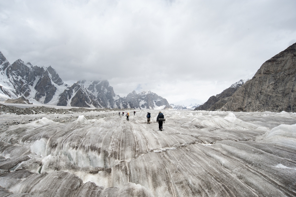 Trekking across black ice on the biafo glacier on route to Hisper La Pass. 