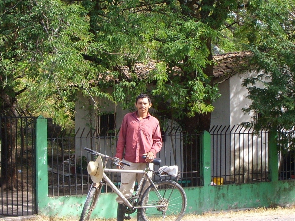 An El Salvadoran man coming home for lunch on his bicycle.