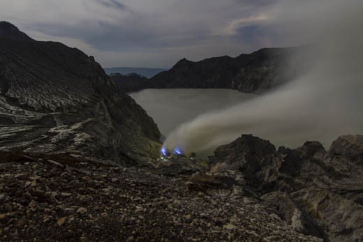 the blue flames of molten sulfur and flashlights of the miners of Ijen