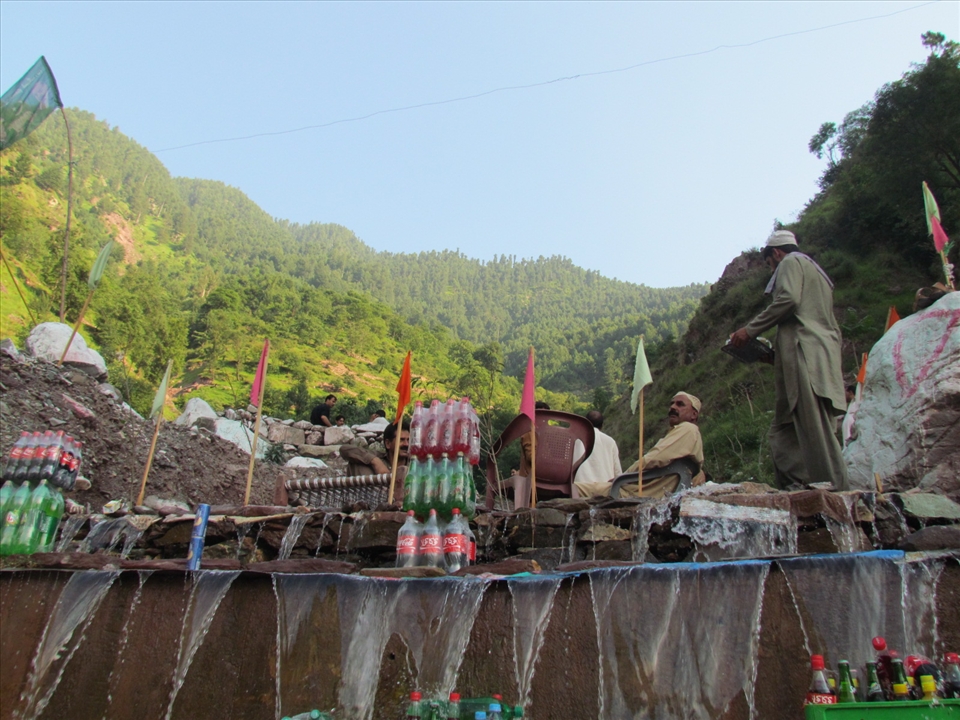 The lush green way to Naran, people  keep cold drinks by cold water of  glaciar 