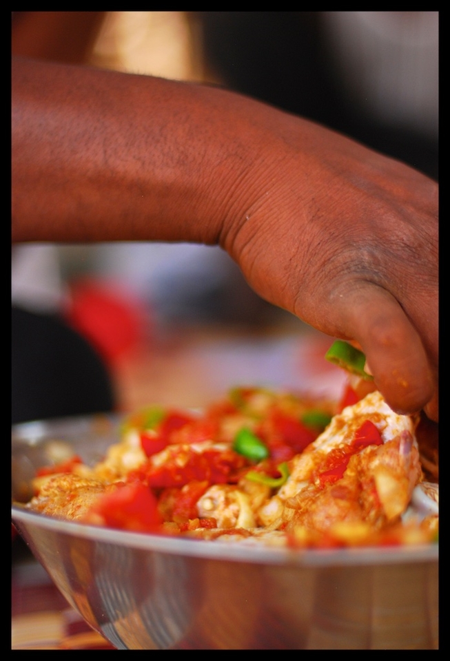 Mohammed marinating the chicken 