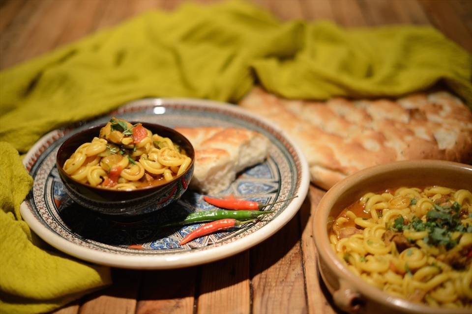 Serve Ubari Chicken in bowls with bread