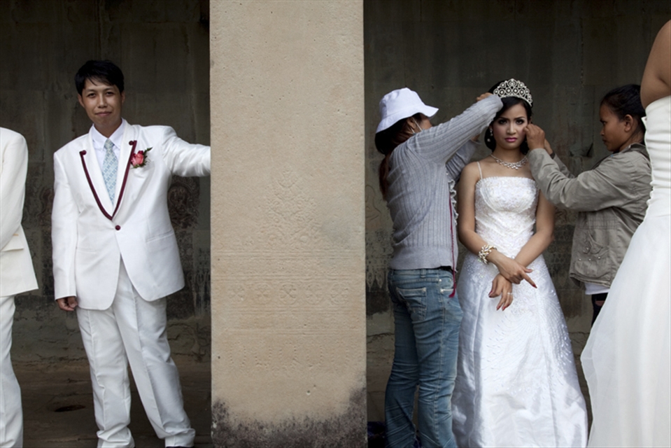 A bridal party prepares for elaborate pre-wedding photos outside the main temple complex. Although foreigners must pay an entrance fee, it’s free for all Cambodians and their relatives to visit this world heritage site.