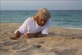 Juma al Humaidi, the ESO field assistant, looks over freshly dug out hatchlings, which were trapped under wet sand. Turtle eggs can be washed away by high tides and hatchlings face staggering natural obstacles. It is human induced threats, however, that have caused dramatic decline in populations.: by natasa, Views[321]